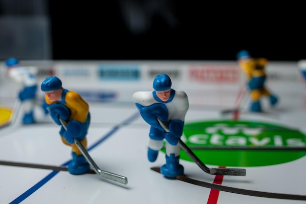 table hockey players dressed in yellow and white table hockey