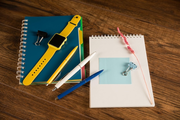 Photo on the table is an empty paper with a notepad and a clock