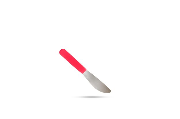 A table knife with red handle floating on a white background with copy space