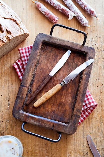 Foto coltelli da tavola su vassoio di legno