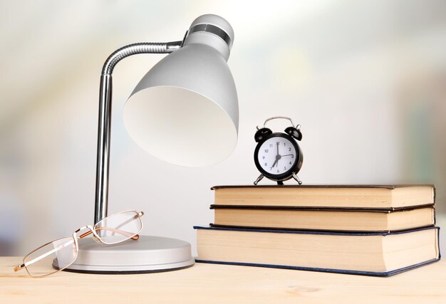 Table lamp and books on desk in room