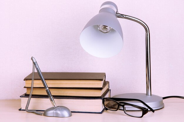 Photo table lamp with books on desk in room