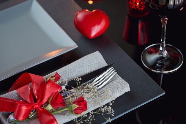 Table place setting with holidays decoration. Romantic dinner.