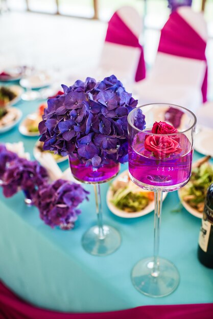 Table in the restaurant decorated with purple flowers, wedding dinner