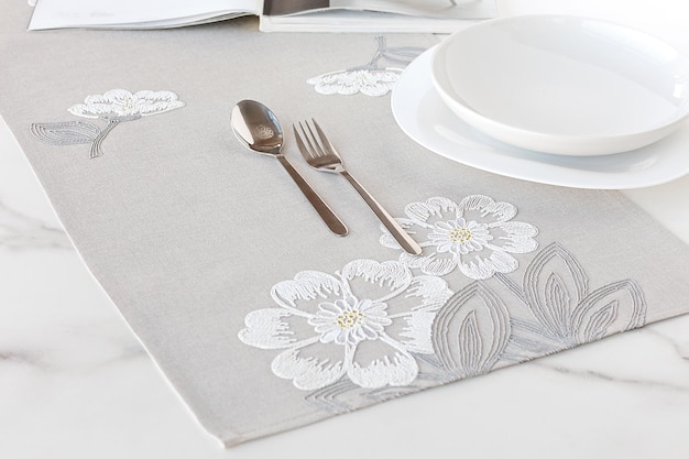 Table runner, napkin or kitchen placemat on cloth with plate and cutlery