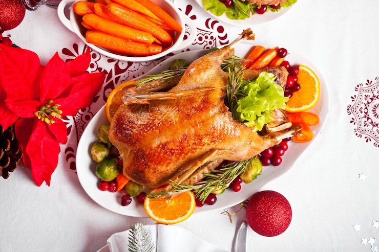 Photo table served for thanksgiving or christmas dinner. stuffed roasted turkey in the foreground. traditional celebrating holiday.