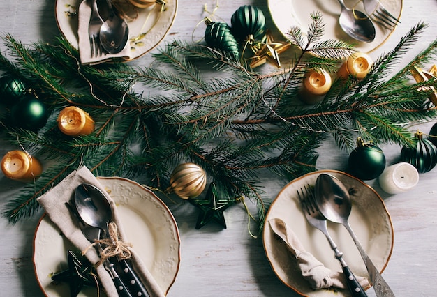 Table served for winter dinner in living room. Close up view, table setting. Christmas and winter decorations.