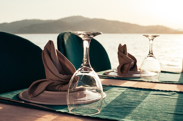 Photo table set at beach restaurant on sunset