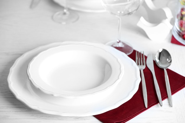 Table set at restaurant on light background