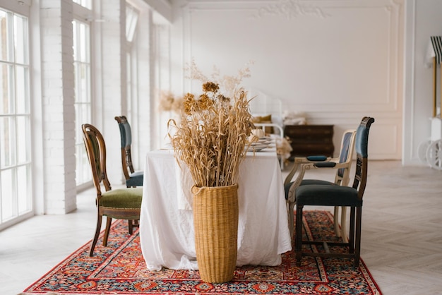 Table set for Thanksgiving with vintage chairs of different shapes and colors