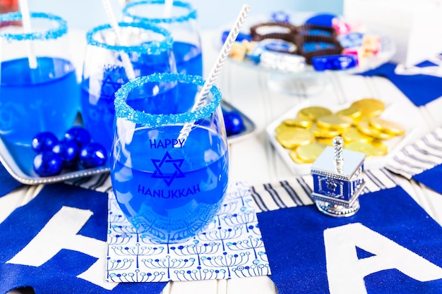 Table set with cocktails and chocolates to celebrate Hanukkah.