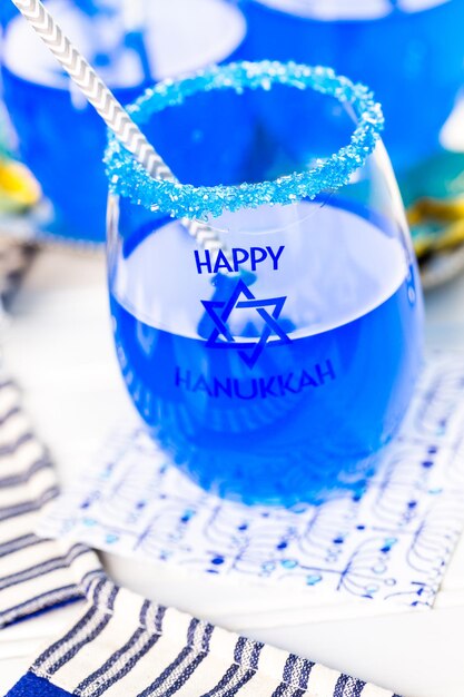 Table set with cocktails and chocolates to celebrate Hanukkah.