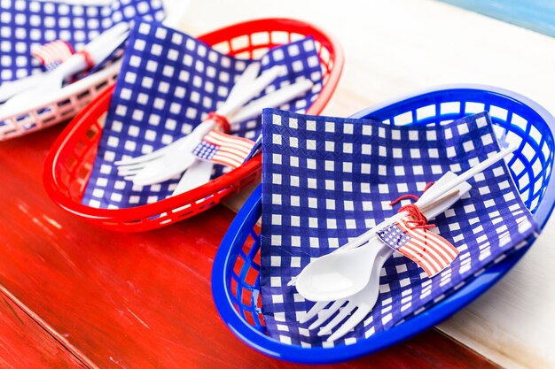 Table set with white, blue and red decorations for July 4th barbecue.