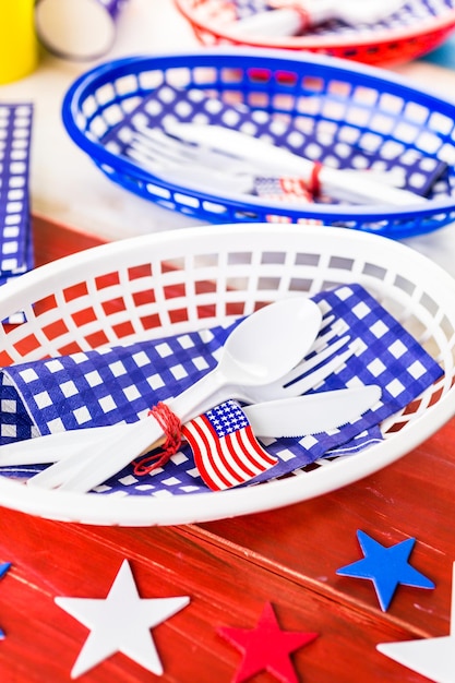 Photo table set with white, blue and red decorations for july 4th barbecue.