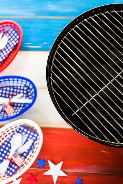 Table set with white, blue and red decorations for July 4th barbecue.