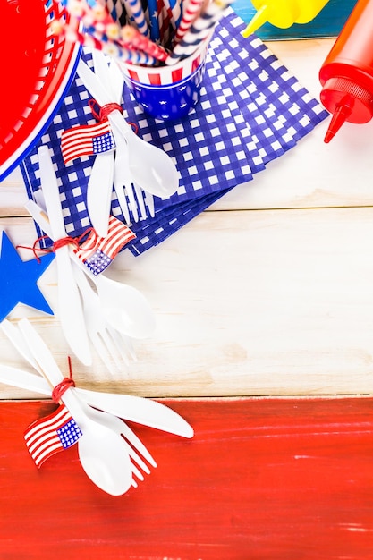 Table set with white, blue and red decorations for July 4th barbecue.