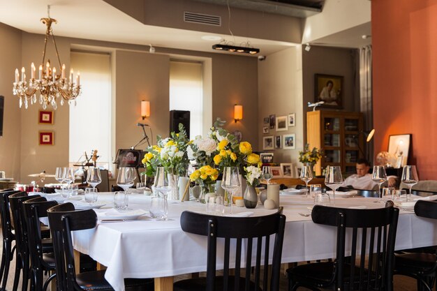 Table set with yellow roses for a festive party