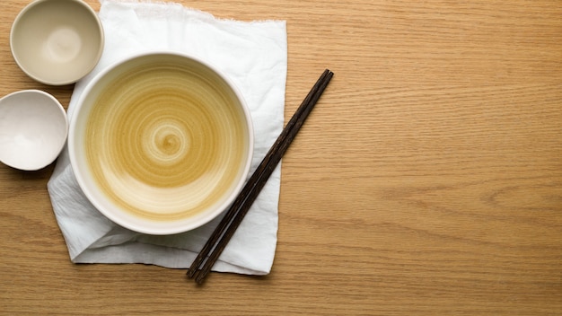 Table Setting Background, mock up ceramic bowls, table cloth and chopsticks on wooden table, copy space