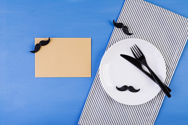 Table setting on Fathers day with cutlery and mustache . Happy Fathers day