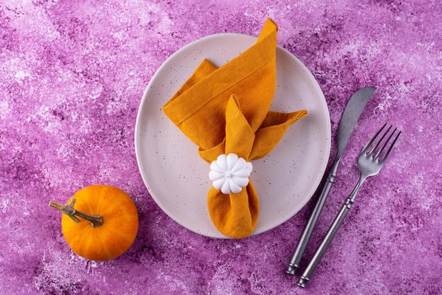 Table setting on lilac concrete background