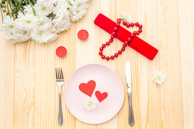 Table setting, love hearts, gift and flowers