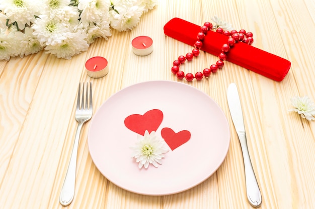 Table setting, love hearts, gift and flowers