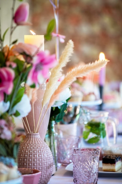 Table setting at a luxury wedding or party babyshower birthday and beautiful flowers cakecandles