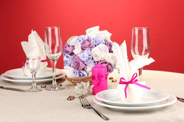 Table setting in purple tones on color background
