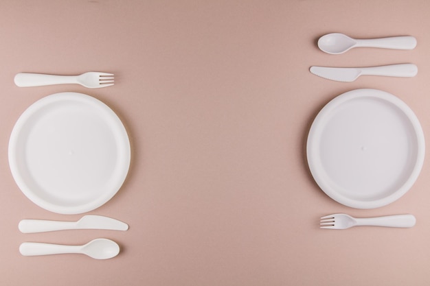 A table setting in a restaurant for two persons with a plate spoon fork knife