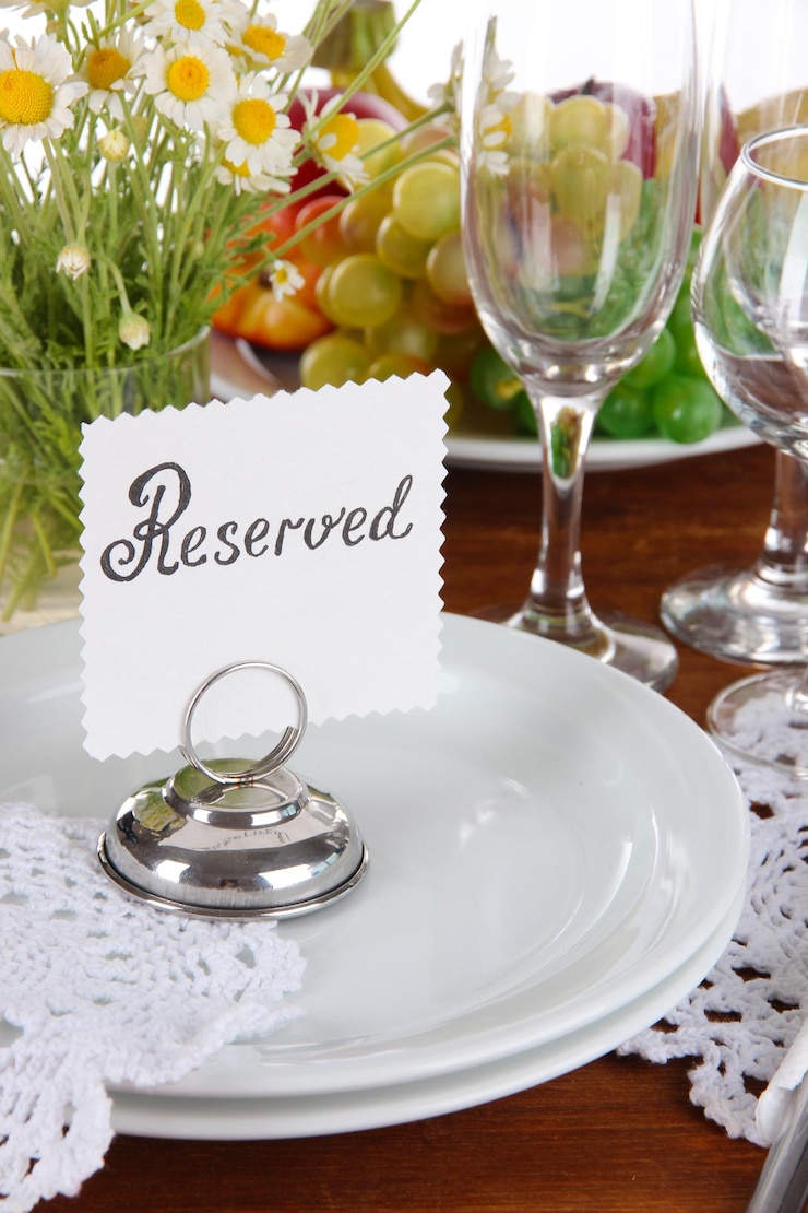 Photo table setting with chamomiles on wooden table closeup
