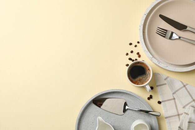 Photo table setting with cup of coffee on beige, top view