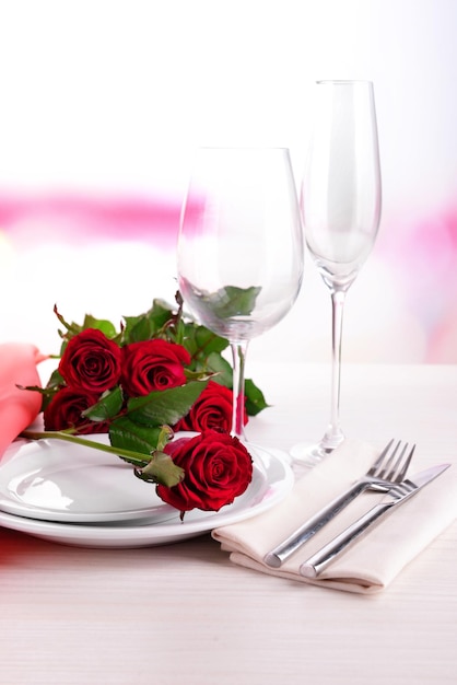 Table setting with red rose on plate