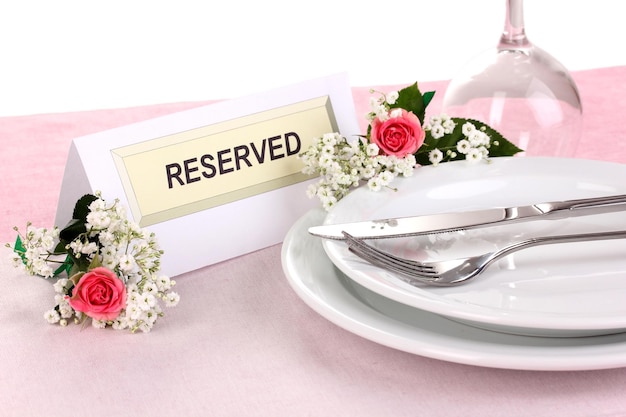 Table setting with reserved card in restaurant