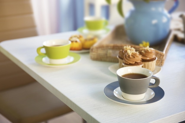 Table setting with tea and cakes indoors