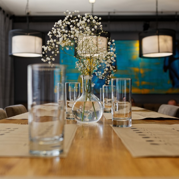 table setting with a vase and a flower