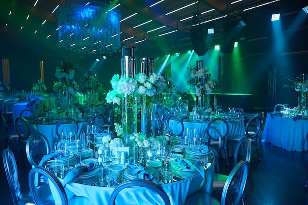 Table setup in blue and green light Ready to event Shallow dof