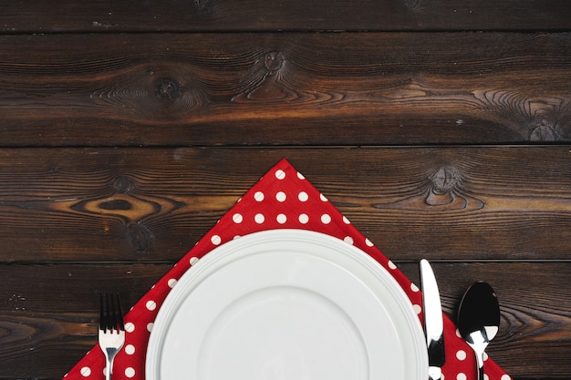 Table setup with plates on dark wooden 