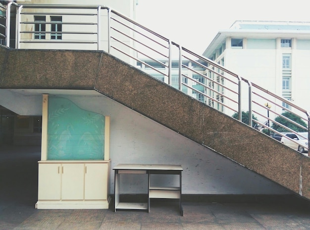 Photo table under staircase in city