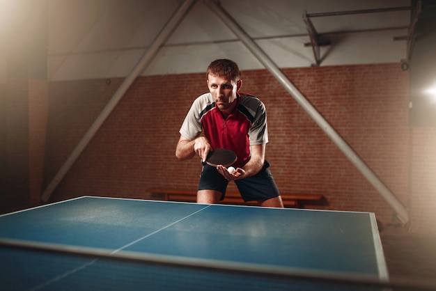 Photo table tennis, male player with racket and ball