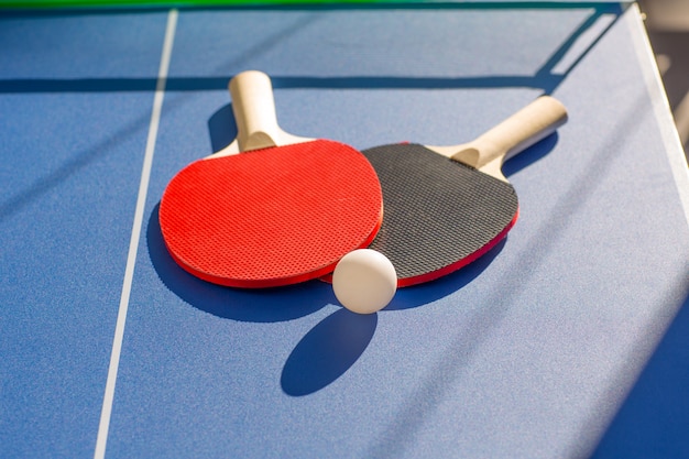 table tennis ping pong two paddles and white ball