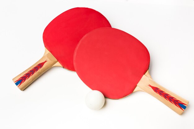 Table tennis racket and ball on a white background