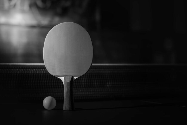 Photo table tennis racket on the blue ping pong table