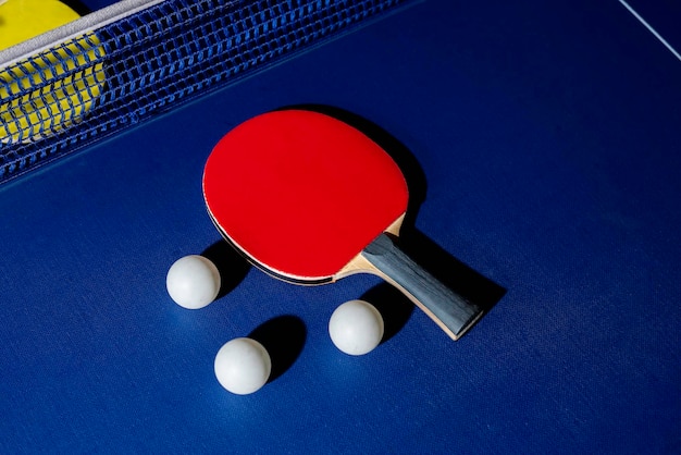 Table tennis racket on the blue ping pong table