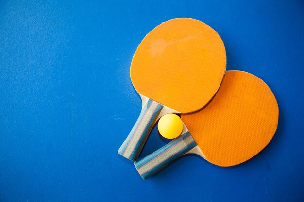 Table tennis rackets against blue background