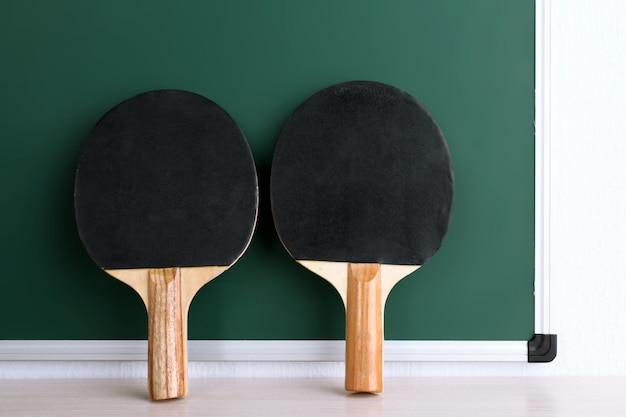 table tennis rackets on blackboard background
