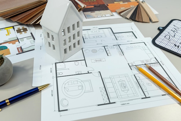 on the table there is a detailed floor plan of a house showcasing its layout and design