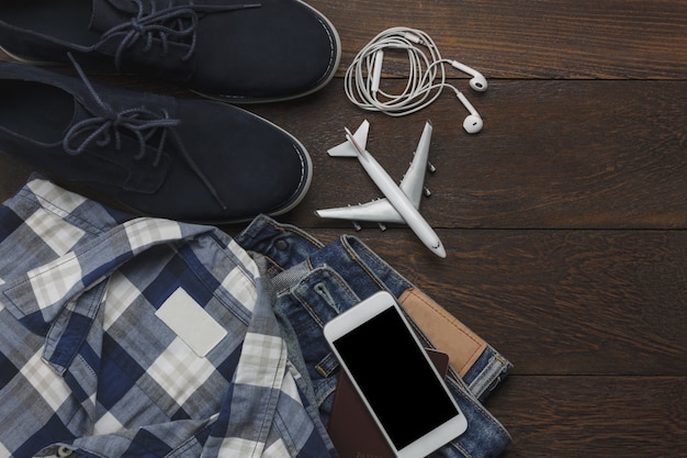 Table top view of accessories fashion men for travel with technology concept.Essential item for the teenage or adult gentlemen and travel for trip holidays.Mix of object on the modern rustic wooden.