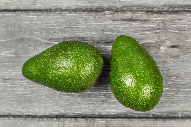 Table top view - two avocado pears on gray wood table