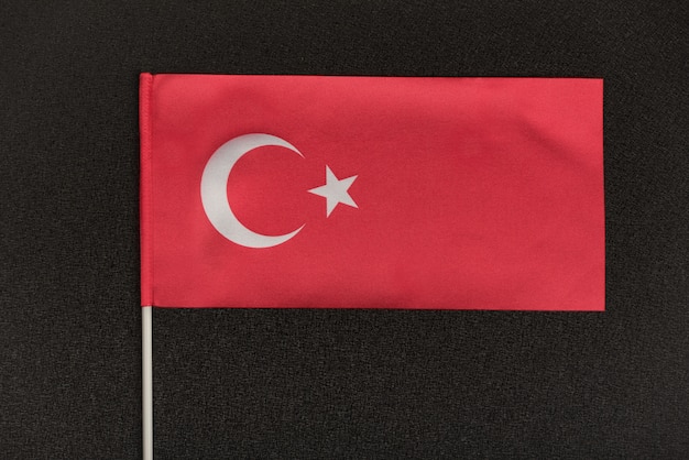 Table Turkish flag on a black background. Symbol