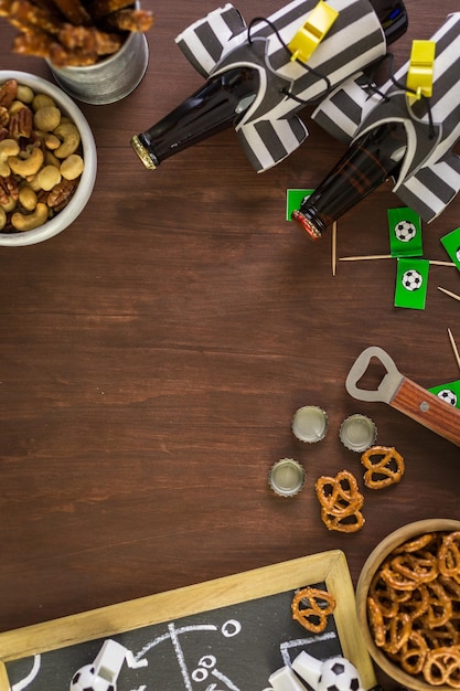 Table with beer and salty snacks for football party.